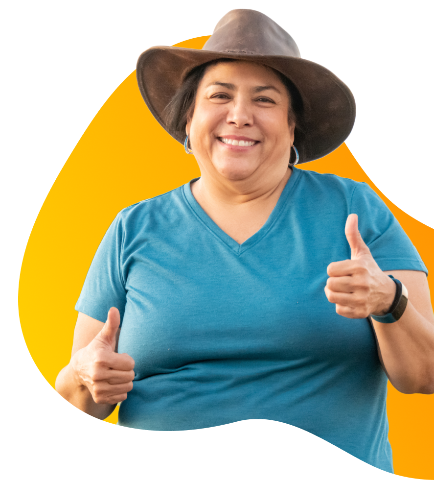 Smiling woman in blue t-shirt and hat giving thumbs-up sign because she has a caravan loan