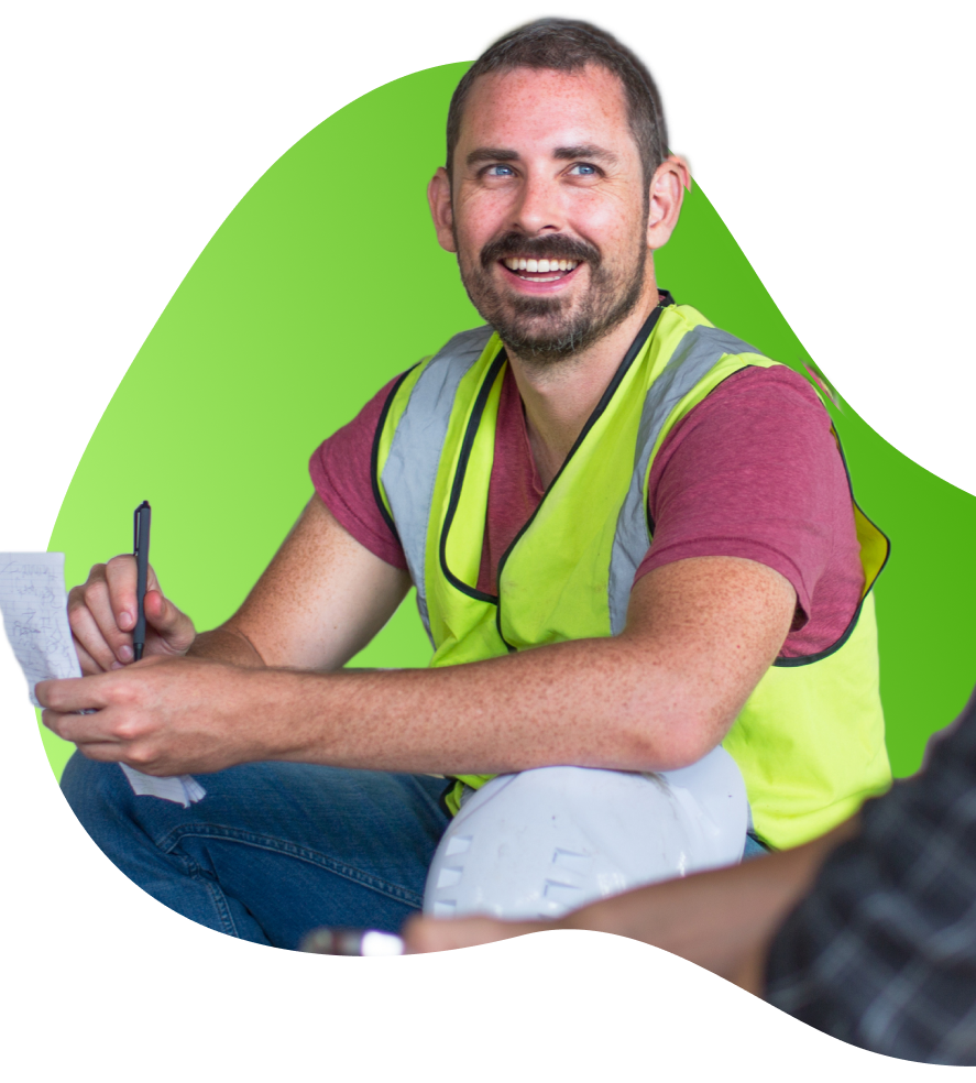 Smiling man in yellow high-vis vest with commercial loan approval from Financfy